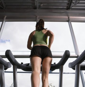 Young Woman Jogging on Treadmill