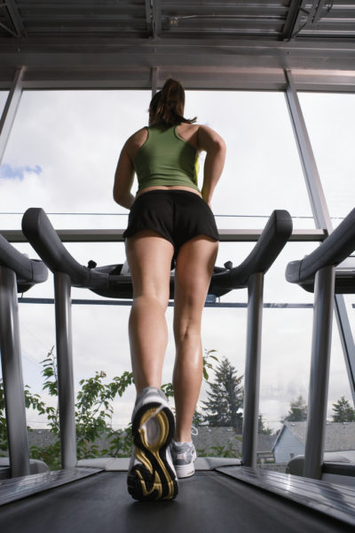 Young Woman Jogging on Treadmill